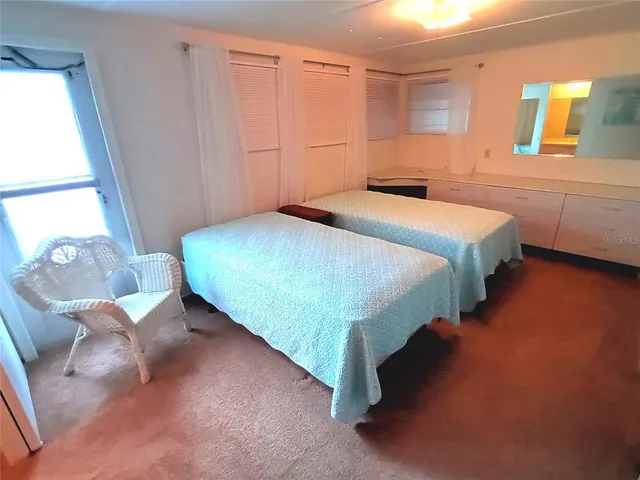 a kitchen with a sink a refrigerator and cabinets