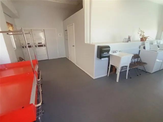 a dining room with furniture and a floor to ceiling window