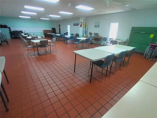 a front view of a house with a garden and trees