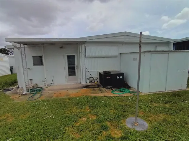 a backyard of a house with table and chairs