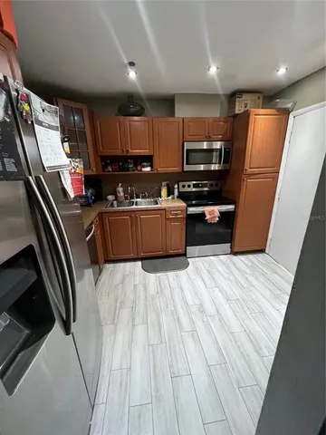 a kitchen with refrigerator and microwave