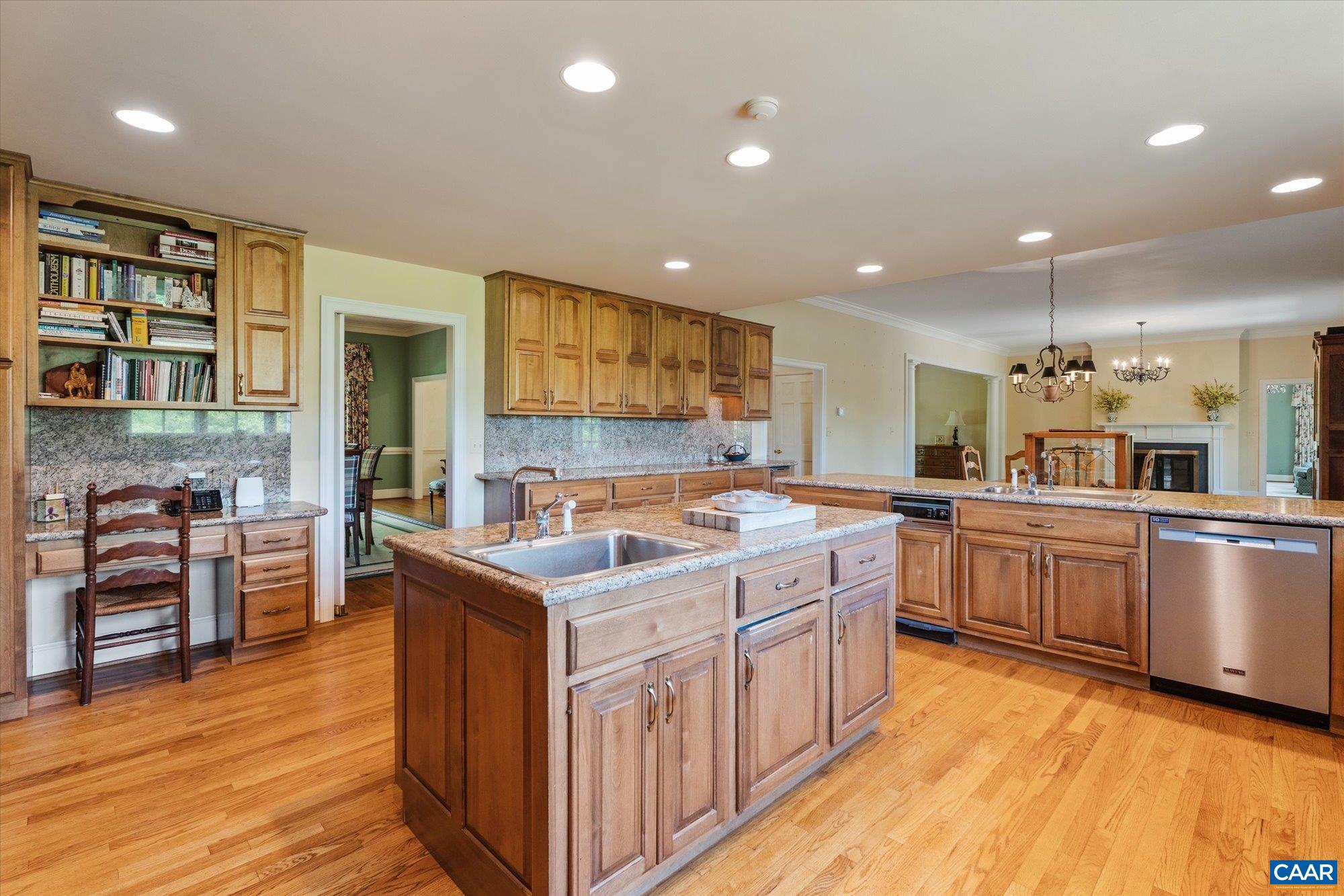 5190 Sugar Ridge Road Crozet, VA 22932 - Photo 27 of 69 a kitchen with stainless steel appliances granite countertop a sink stove and wooden cabinets