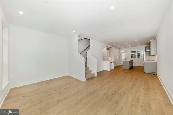 a view of a room with gym equipment and a kitchen view