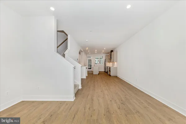 a view of a room with wooden floor and stairs