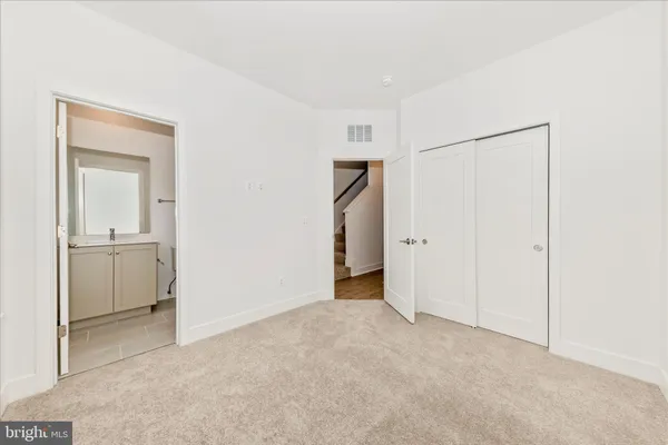 a bathroom with a sink toilet vanity and shower