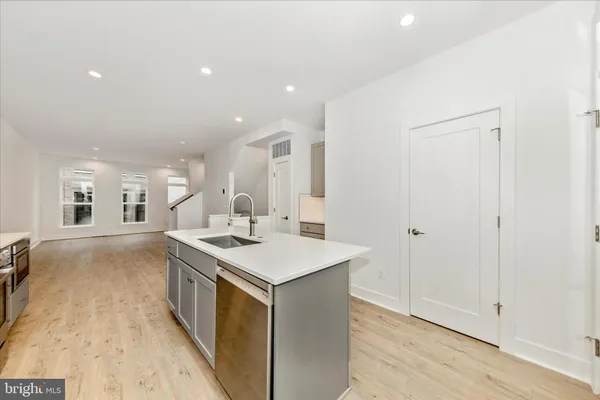 a kitchen with a sink and a stove top oven