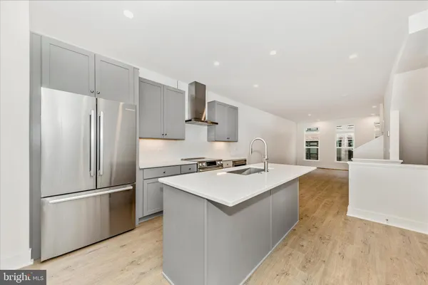 a kitchen with stainless steel appliances a refrigerator and a stove