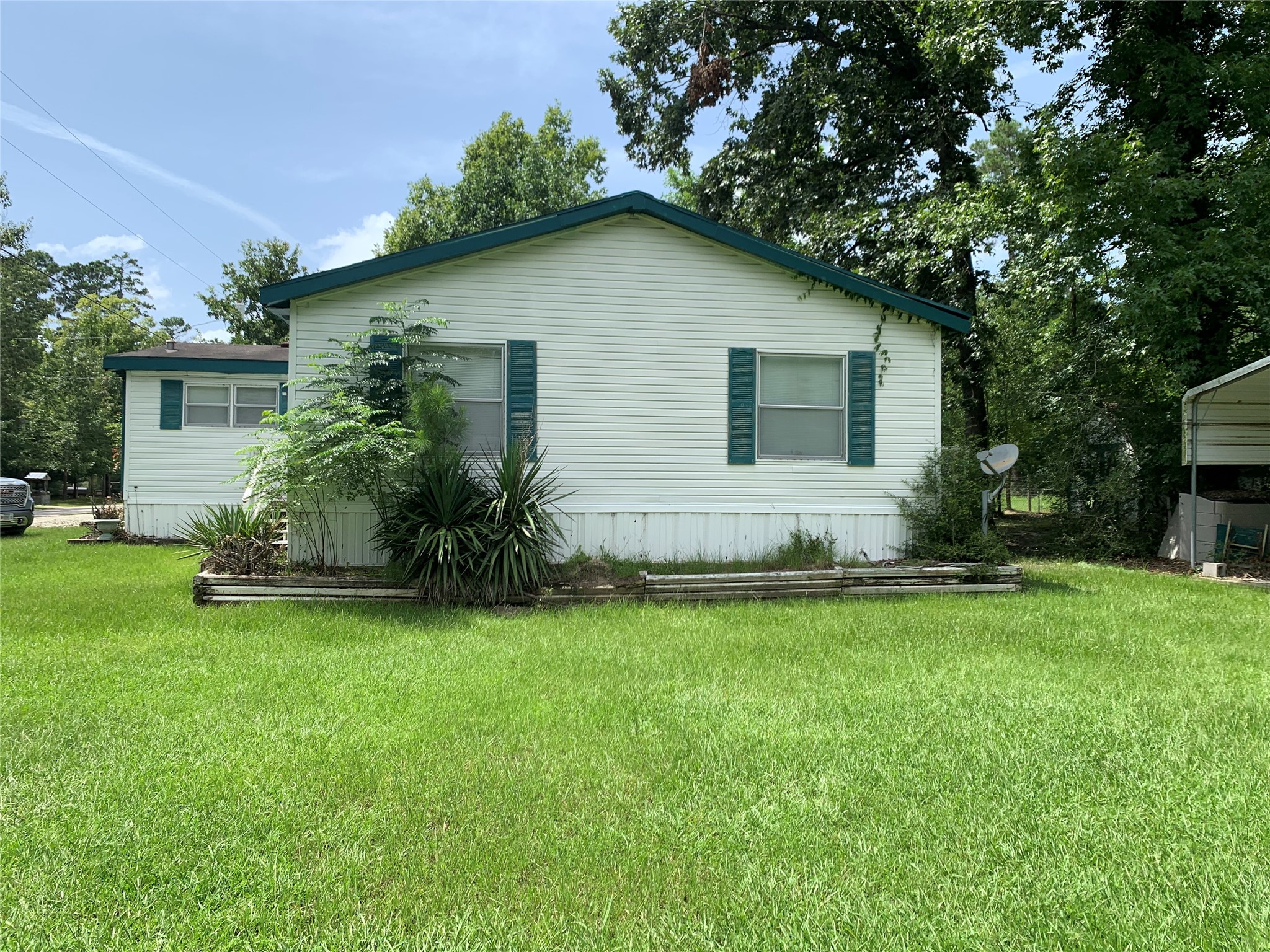 305 Canadian Drive Trinity, TX 75862 - Photo 28 of 29 a house that is sitting in the grass