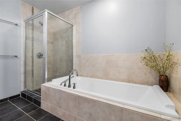 a bathroom with a bathtub and shower
