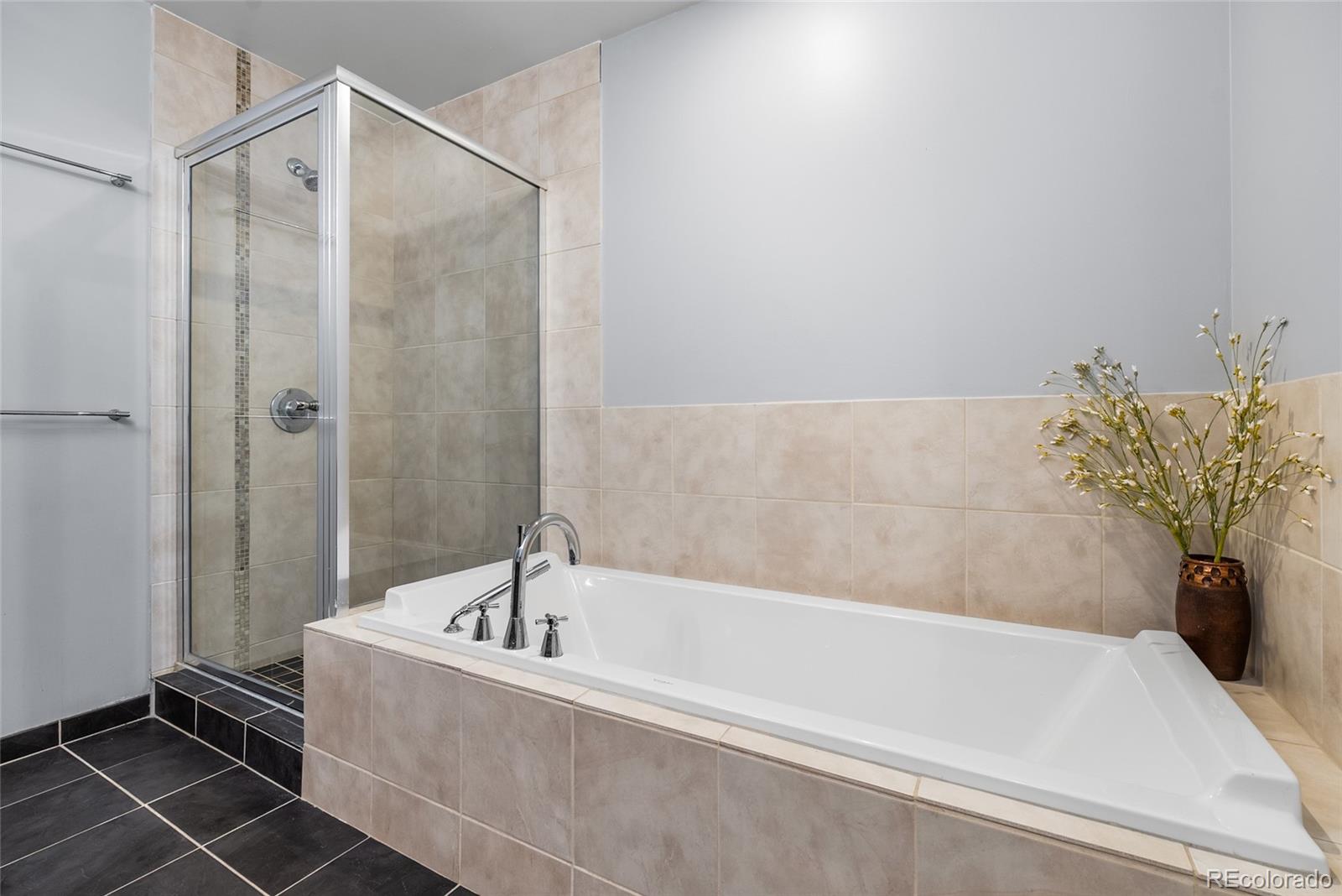 410 Acoma Street, Unit 511 Denver, CO 80204 - Photo 11 of 27 a bathroom with a bathtub and shower