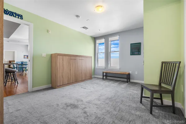 a view of a room with furniture and a window