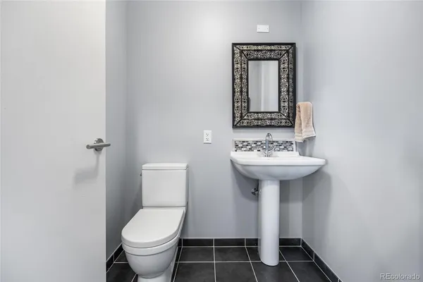 a bathroom with a sink toilet and mirror