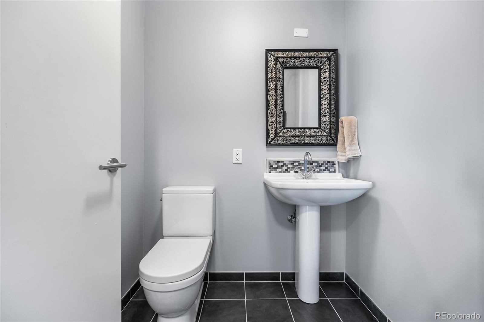 410 Acoma Street, Unit 511 Denver, CO 80204 - Photo 16 of 27 a bathroom with a sink toilet and mirror