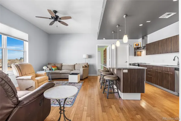 a living room with furniture and kitchen view