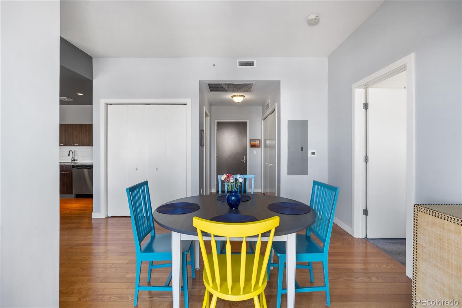 410 Acoma Street, Unit 511 Denver, CO 80204 - Photo 7 of 27 a view of a dining room with furniture and wooden floor