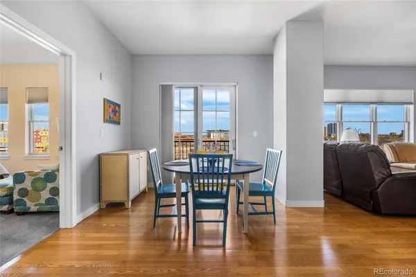 a dining room with furniture and wooden floor