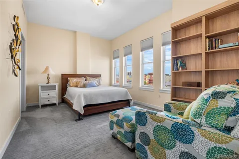 a bedroom with bed and a book shelf