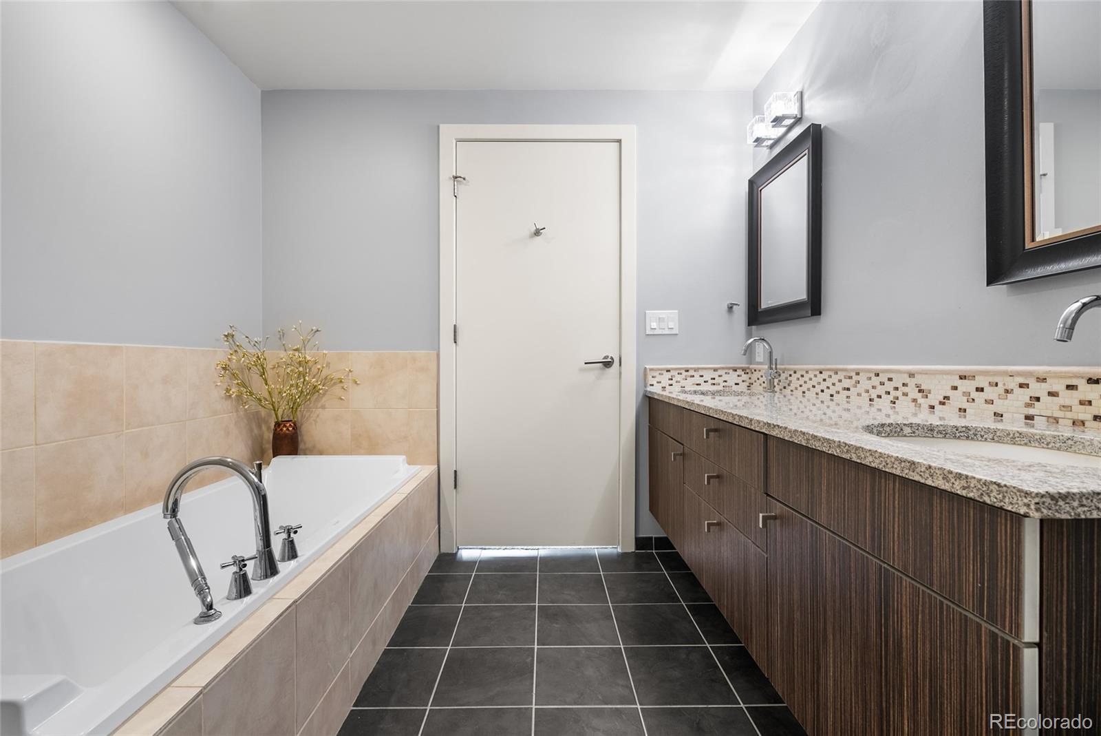 410 Acoma Street, Unit 511 Denver, CO 80204 - Photo 10 of 27 a bathroom with a tub sink and mirror