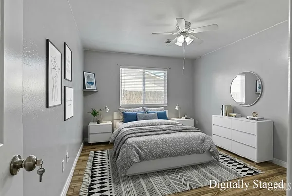 a bedroom with a large bed and a chandelier