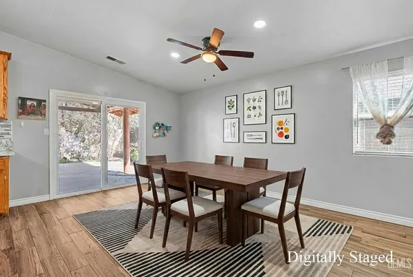 a view of a dining room with furniture wooden floor and a chandelier