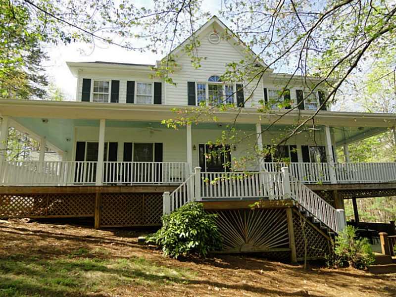 6030 River Road Flowery Branch, GA 30542 - Photo 1 of 1 Exterior Front. Private and spacious home with wraparound porch on 2.26 +/- wooded acres. Besides the 2 car garage, guests have a parking pad.
