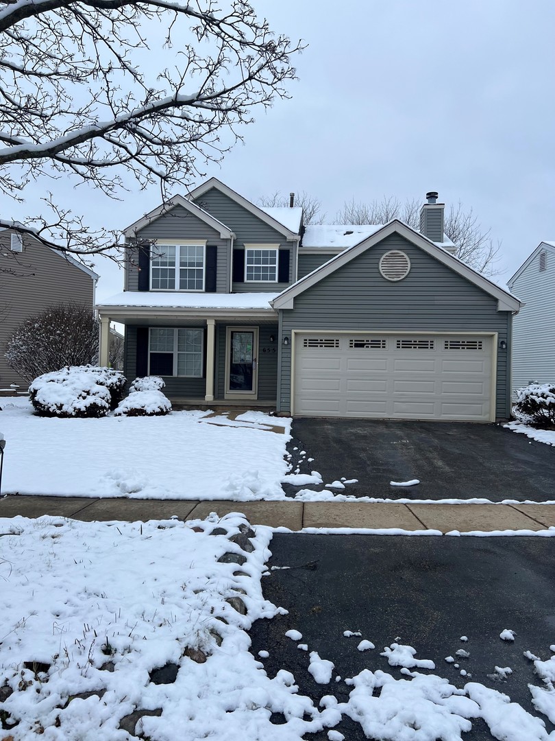 655 Nichole Lane Geneva, IL 60134 - Photo 1 of 11 a front view of a house with a yard