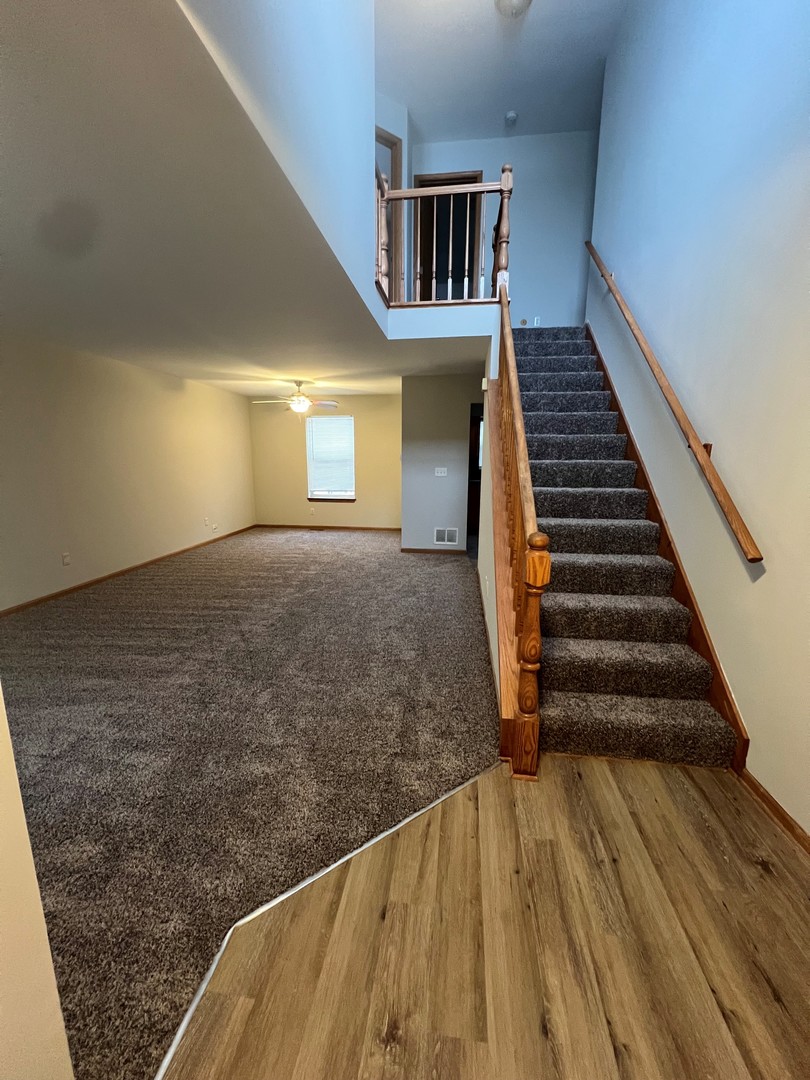 655 Nichole Lane Geneva, IL 60134 - Photo 3 of 11 a view of entryway and hall with wooden floor