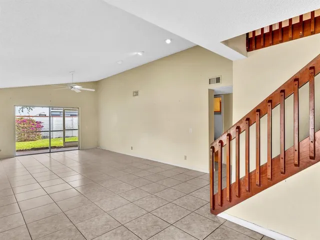 a view of a hallway with windows and stairs
