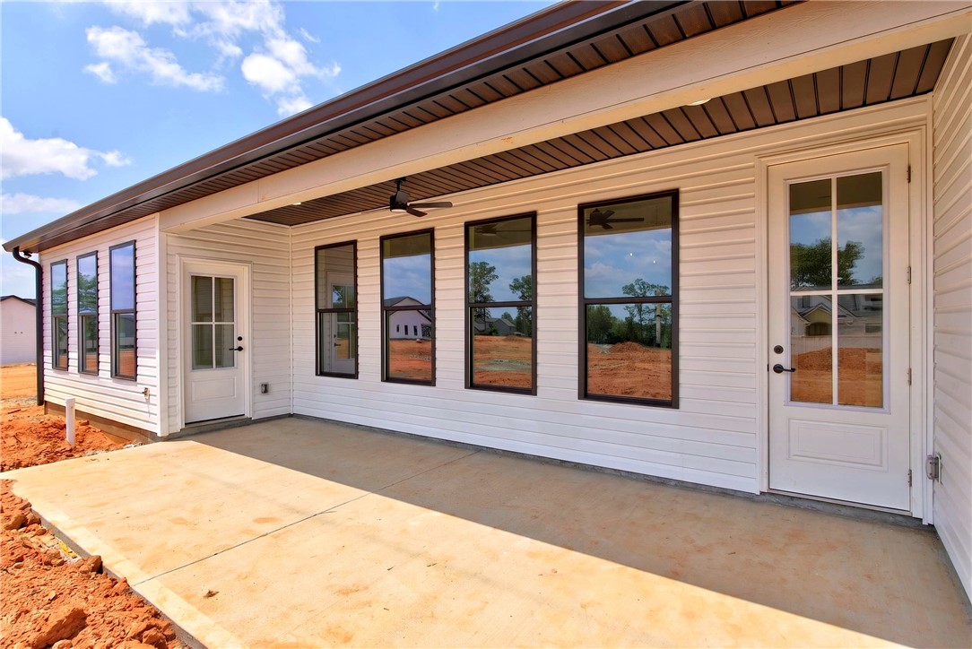 424 Blume Road Anderson, SC 29625 - Photo 27 of 30 A spacious concrete patio extends from a newly constructed residence, ideal for outdoor gatherings.
