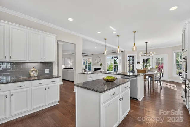 a kitchen with white cabinets and stove