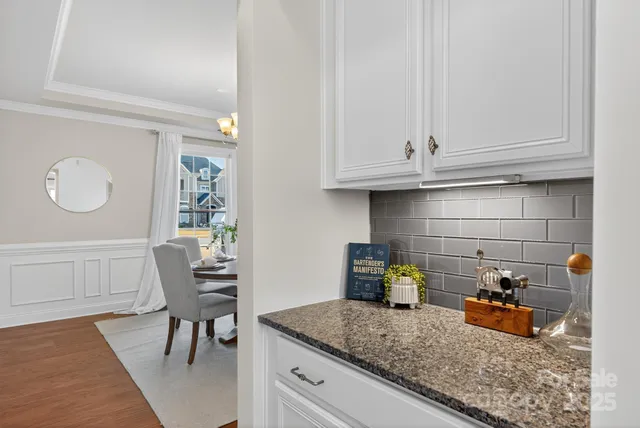 a kitchen with a sink a stove and cabinets