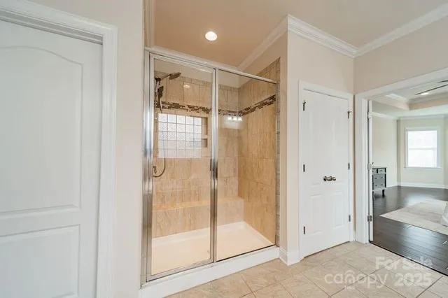 a bathroom with a glass shower door