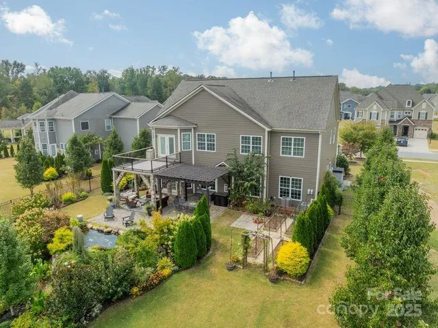 an aerial view of a house with a swimming pool