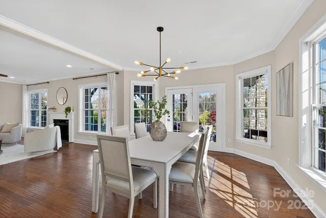 a view of a dining room with furniture wooden floor and chandelier