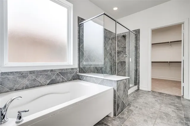 a bathroom with a bathtub and a shower