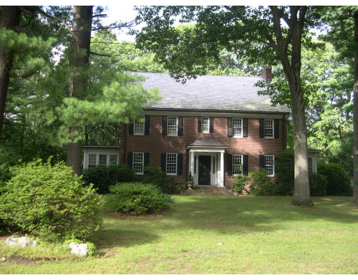 23 Old Colony Road Weston, MA 02493 - Photo 1 of 8 a front view of a house with a garden