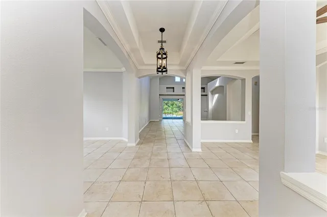 a view of a hallway with a chandelier