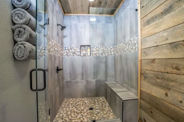 an aerial view of residential house with outdoor space and trees all around