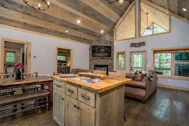 an aerial view of a house with a garden and lake view