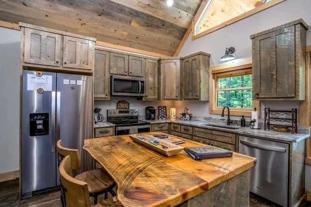 an aerial view of residential houses with outdoor space and trees
