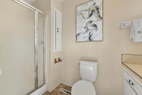 a white toilet sitting next to a shower curtain