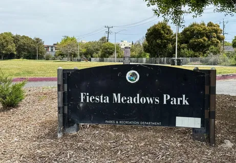 a view of outdoor space with a garden and signage