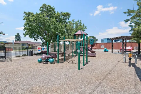 a view of a patio with a table and chairs under an umbrella