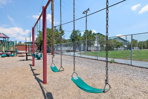 a view of a park with iron fence