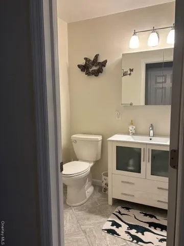 a bathroom with a toilet a sink and a mirror