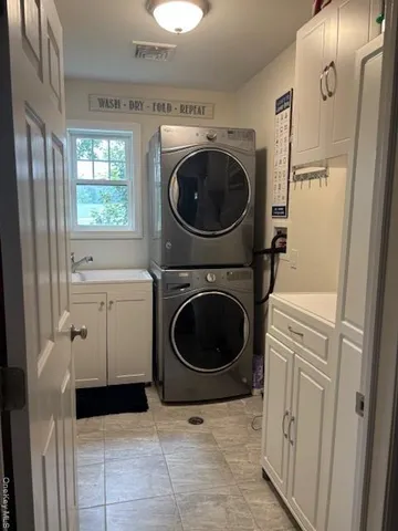 a utility room with sink dryer and washer