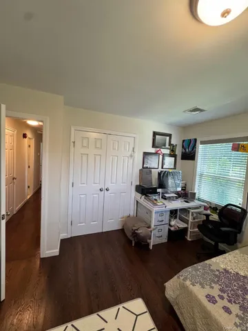a view of a workspace with furniture and wooden floor