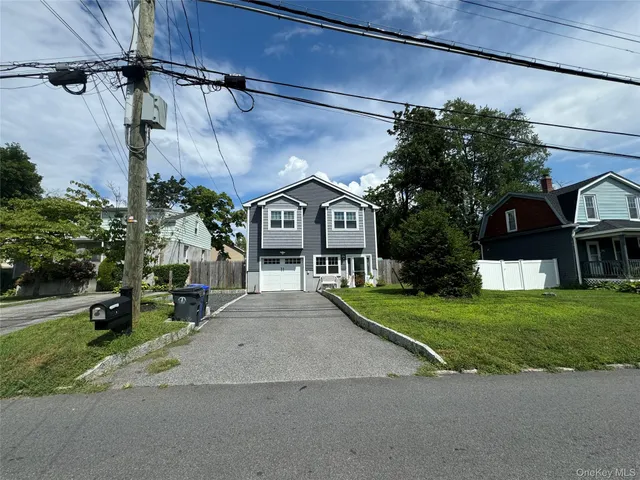 a front view of a house with a garden and pathway