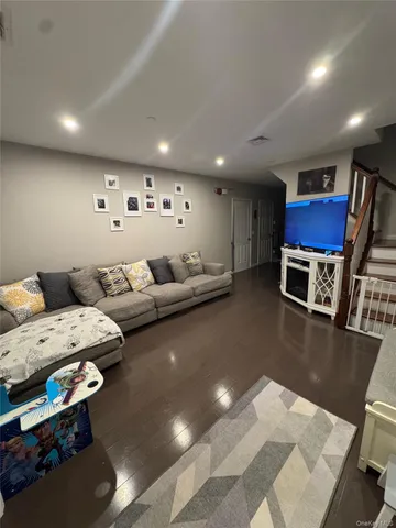 a living room with furniture and a pool table