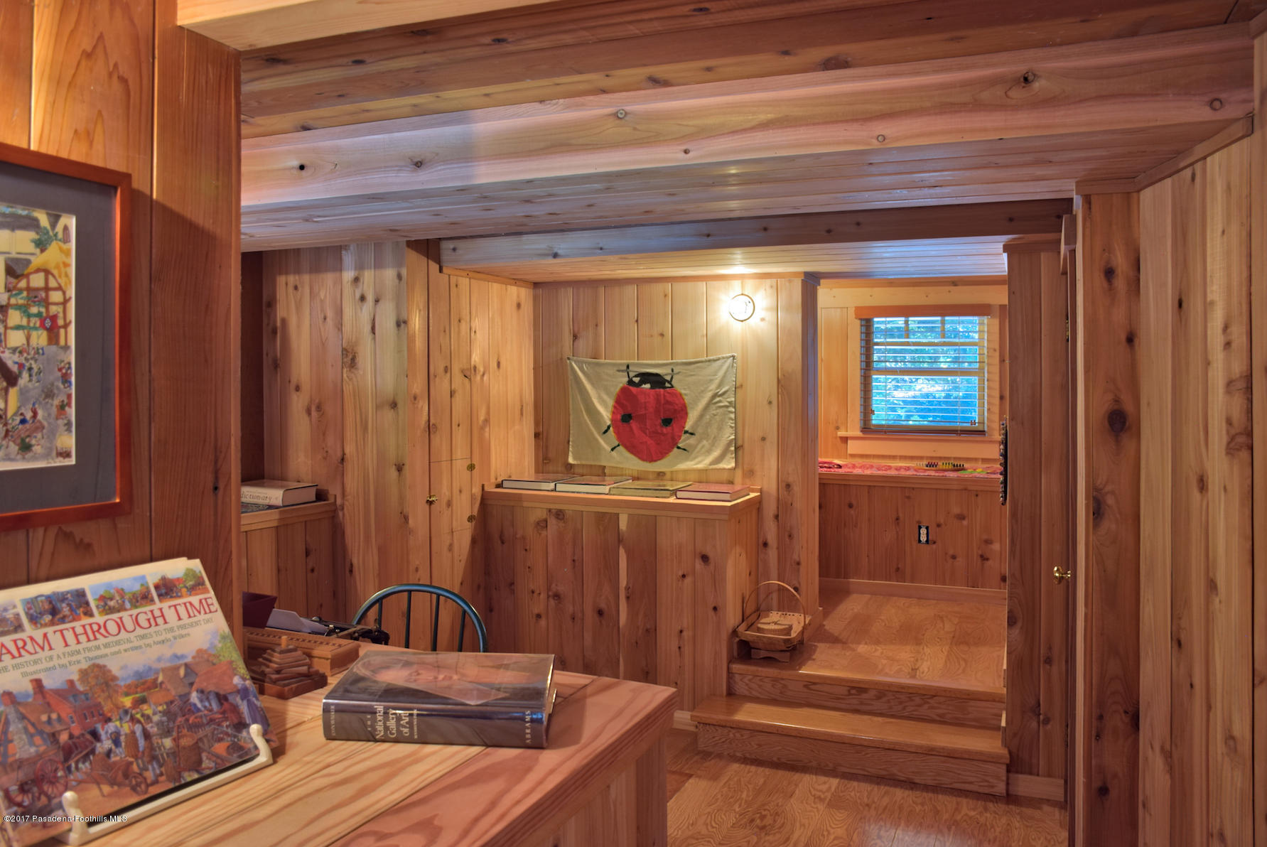 53225 Tollgate Road Idyllwild, CA 92549 - Photo 14 of 24 a view of a bedroom with baby crib and furniture
